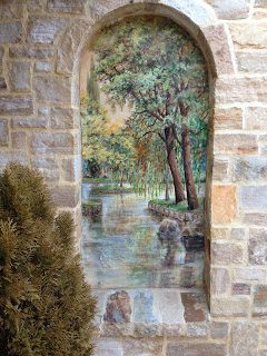 Painted landscape in arched niche