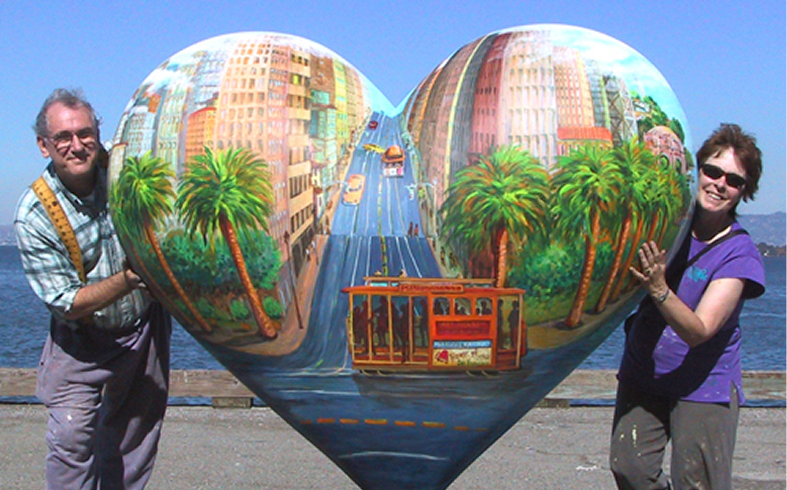 Man and woman with cityscape heart sculpture