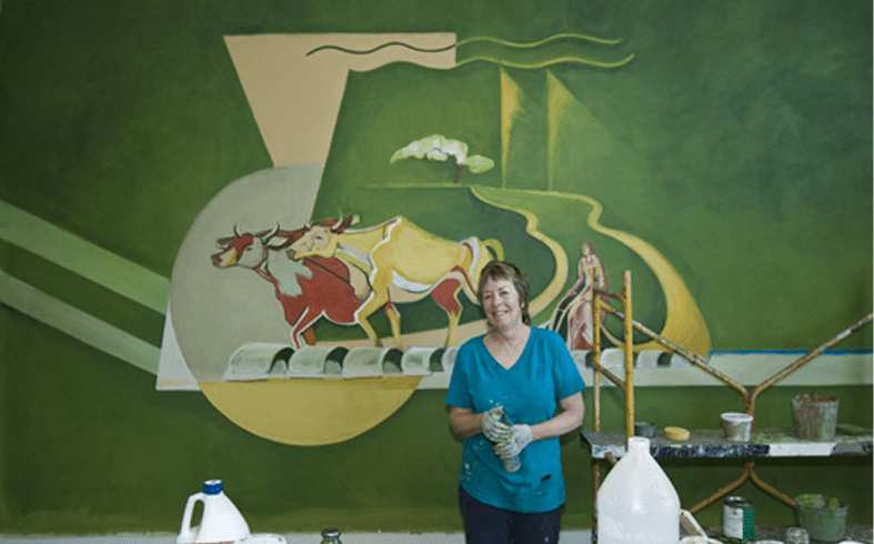 Creative mural art with smiling artist