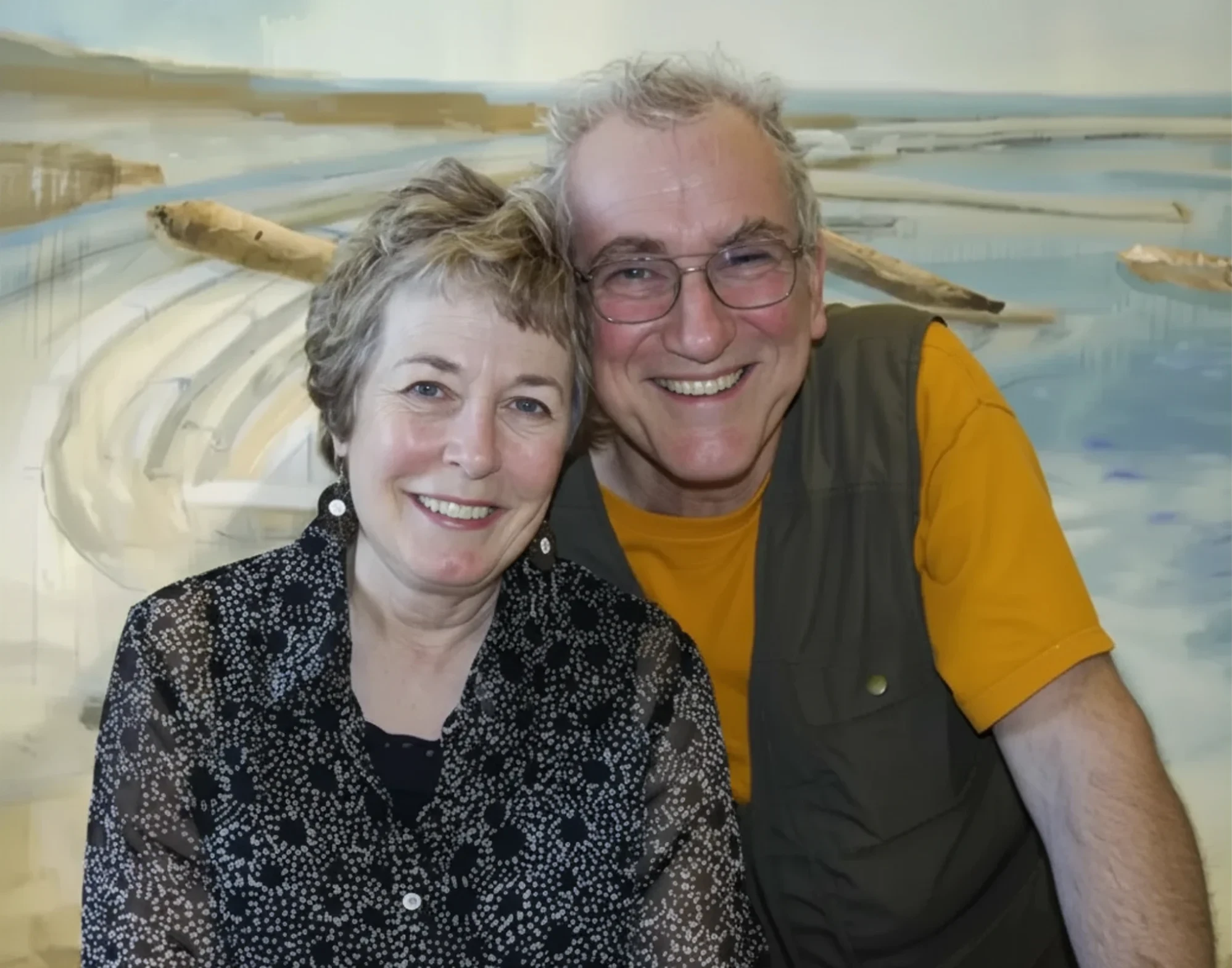 Smiling couple posing in front of artwork